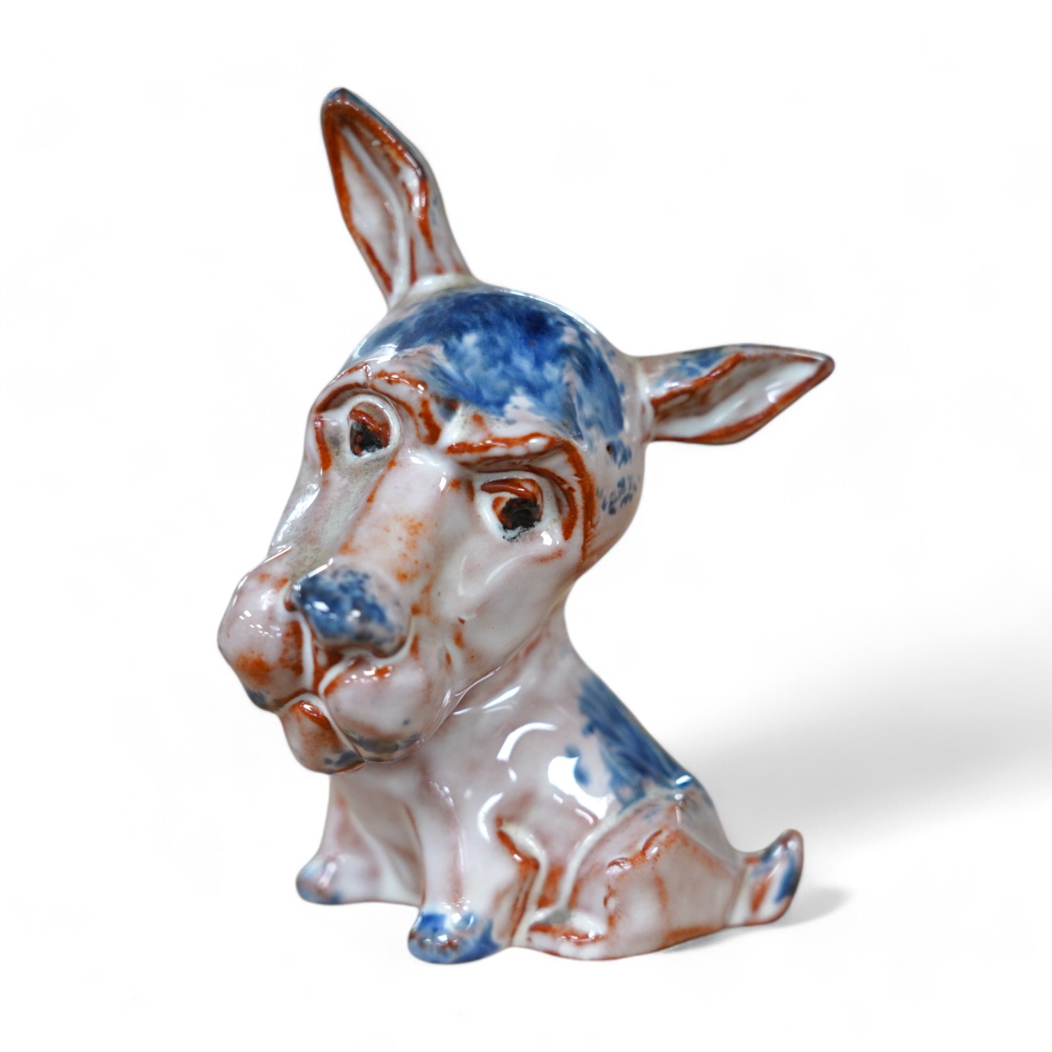 An unusual early Goebel tin glazed terracotta grotesque dog, in the style of Ida Meisinger, impressed no. KT.626., 10.5cm. Condition - good